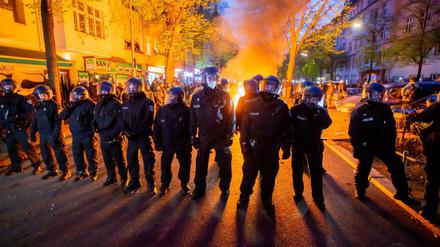 Polizisten stehen am 1. Mai 2021 vor einem Feuer am Rande der "Demonstration zum revolutionären 1. Mai".