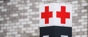 Ein Schild mit einem roten Kreuz. 