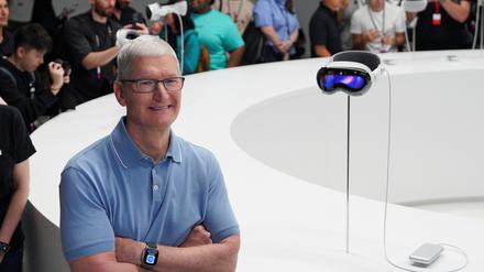 Apple CEO Tim Cook stands next to Apple's Vision Pro headset at Apple's annual Worldwide Developers Conference at the company's headquarters in Cupertino, California, U.S. June 5, 2023. REUTERS/Loren Elliott 