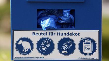 Ein Spender mit Beuteln für Hundekot ist am 11.06.2013 an einem Grünstreifen in Berlin aufgestellt.