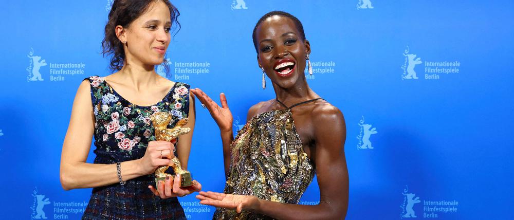 French-Senegalese filmmaker and actress Mati Diop (L) poses with the Golden Bear for Best Film for the film "Dahomey" with Kenyan-Mexican actress and President of the International Jury 2024 Lupita Nyong‘o back stage during the awards ceremony of the 74th Berlinale International Film Festival, on February 24, 2024 in Berlin. (Photo by NADJA WOHLLEBEN / POOL / AFP)