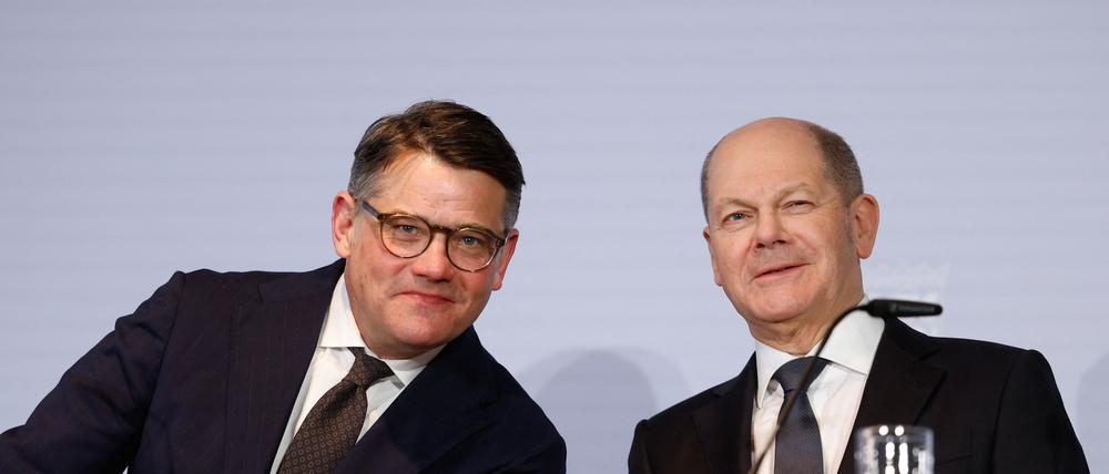 German Chancellor Olaf Scholz (R) and Hesse's State Premier Boris Rhein (L) react during a joint press conference after a meeting with regional leaders on March 6, 2024 in Berlin, to discuss the country's current migration policy. (Photo by Odd ANDERSEN / AFP)