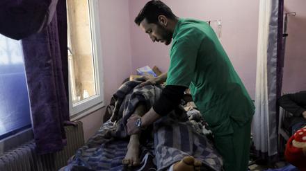Ein Arzt im syrischen Erdbebengebiet untersucht einen Patienten.