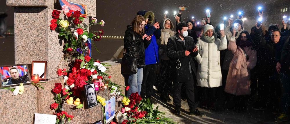 Menschen in St. Petersburg an einer Gedenkstelle für Opfer politischer Repression.