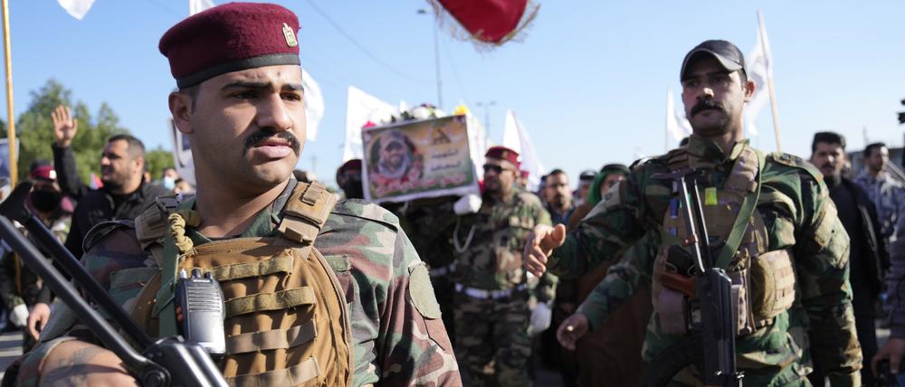Mitglieder einer irakischen schiitischen militanten Gruppe tragen den Sarg eines Kämpfers der Hisbollah-Miliz Kataib.