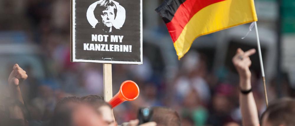 Besucher einer CDU-Wahlkampfveranstaltung protestieren im Erzgebirge gegen Angela Merkel. 