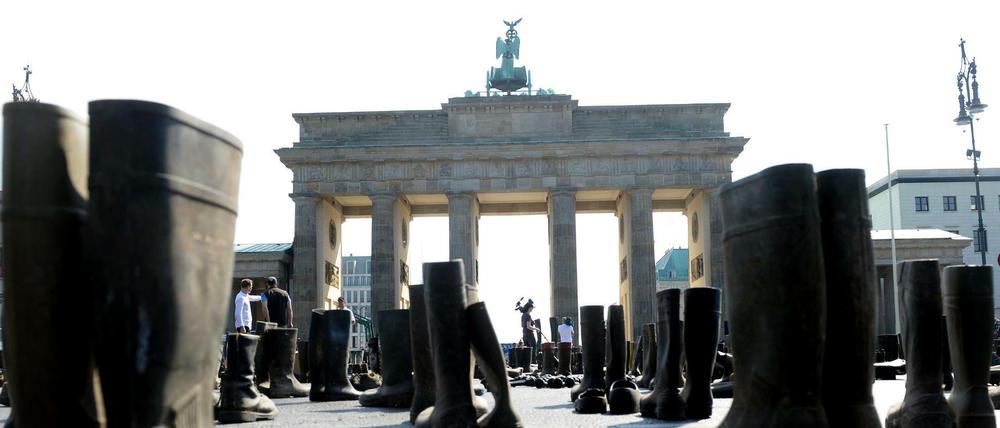 Aktivisten des Bundesverbands Deutscher Milchviehhalter stellten am Brandenburger Tor Gummistiefel auf, um damit die hohe Zahl der aufgegebenen Höfe zu symbolisieren.