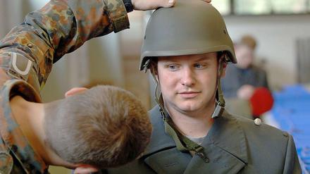 Beim Einkleiden in der Kaserne kommt es auch auf den richtigen Sitz des Helms an. 