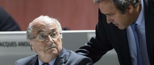 FILES - A picture taken on May 29, 2015 shows FIFA President Sepp Blatter (L) listening to UEFA President Michel Platini during the 65th FIFA Congress in Zurich. Embattled FIFA chief Joseph Blatter is suspected of "disloyal payment" to UEFA head Michel Platini, who had hoped to succeed him, the office of Switzerland's attorney general said on September 25, 2015. AFP PHOTO / FABRICE COFFRINI