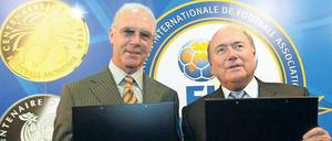 Was kann man hier noch für bare Münze nehmen? Franz Beckenbauer und Fifa-Präsident Joseph Blatter stellen 2004 Gedenkmünzen für die WM 2006 vor. 