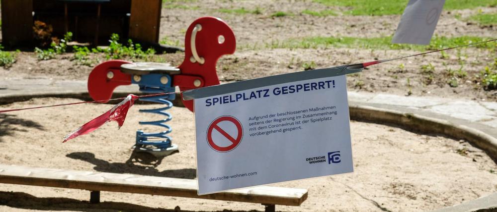 Absperrbänder und ein Schild "Spielplatz gesperrt" auf einem Spielplatz in Berlin-Charlottenburg.
