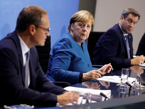 Da lief bei der SPD gerade die Auszählung: Michael Müller mit Kanzlerin Angela Merkel und Bayerns Ministerpräsident Markus Söder.