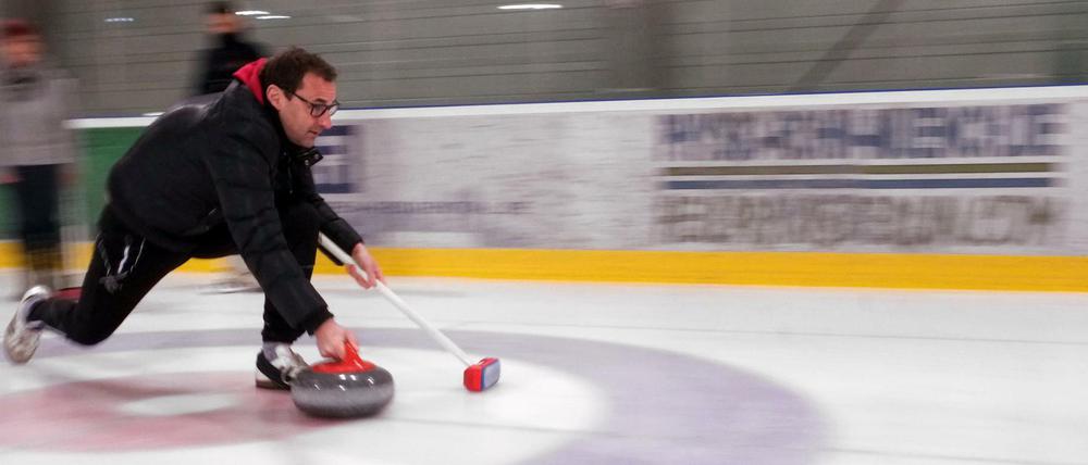 Ein Sportler trainiert Curling.