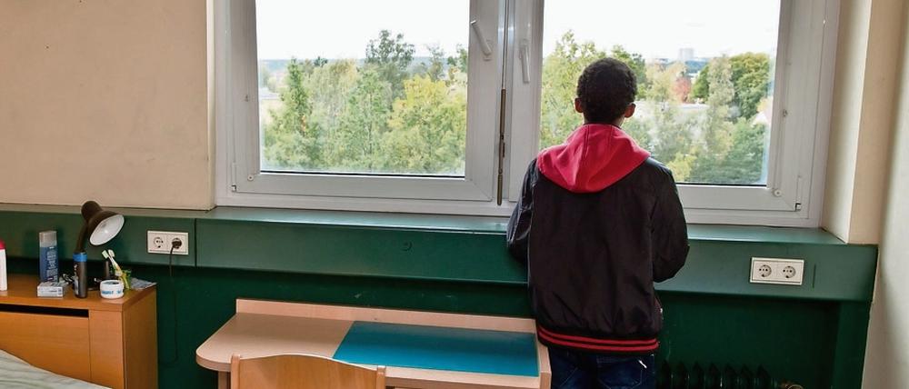 Ein 16-jähriger Flüchtling am Fenster seines Zimmers in einer Wohngruppe für unbegleitete minderjährige Flüchtlinge. 