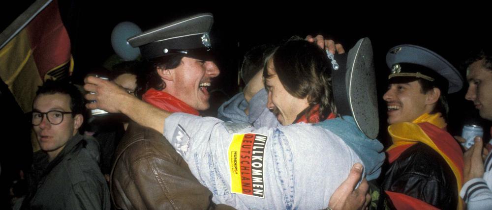 Komm in meine Arme: Feuchtfröhlich Wiedervereinte bei den Feierlichkeiten zum 3. Oktober 1990 am Brandenburger Tor.