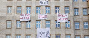 Plakate gegen den Verkauf von Mietwohnungen an einer Gebäudefassade in der Karl-Marx-Allee.