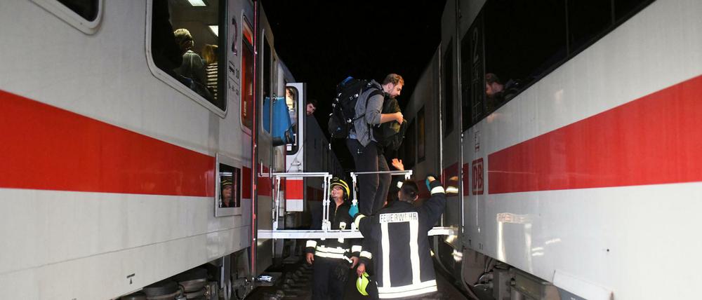 Einsatzkräfte von Polizei und Feuerwehr bergen Passagiere aus einem IC-Zug nach einem Wildunfall vor.