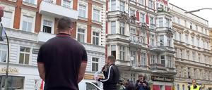 Der Berliner NPD-Chef Sebastian Schmidtke (mit Mikrofon) spricht vor dem berüchtigten Haus (hinter dem Mann mit der Kamera) in der Grunewaldstraße.