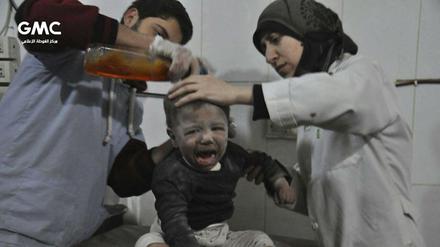 Zwei Ärzte versorgen einen syrischen Jungen, der während des Angriffs der syrischen Luftwaffe in Ost-Ghouta verwundet worden ist.