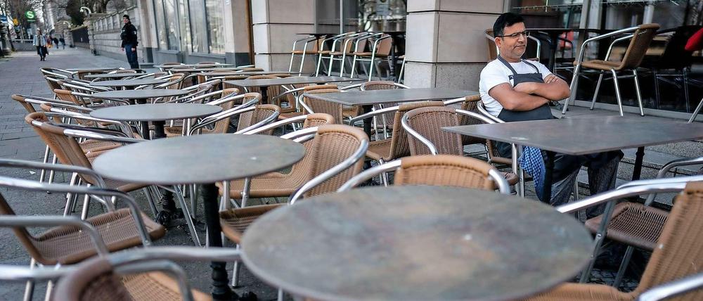 Keine Gäste. Das Corona-Virus bedroht auch Berlins Gastronomie. Das kann im Stadtbild jeder sehen. Dieser Kellner wartet im Café Lebensart Unter den Linden allein auf Gäste.