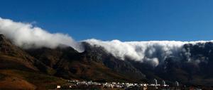 Wolken türmen sich über der Bergkette mit dem berühmten Tafelberg über den Dächern der südafrikanischen Metropole Kapstadt. 