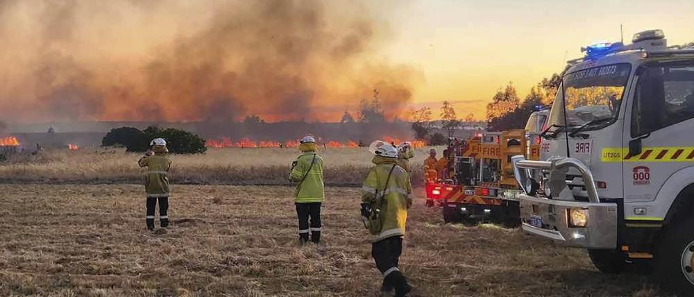 Feuerwehrleute beobachten in den frühen Morgenstunden einen Vegetationsbrand nördlich von Perth. 