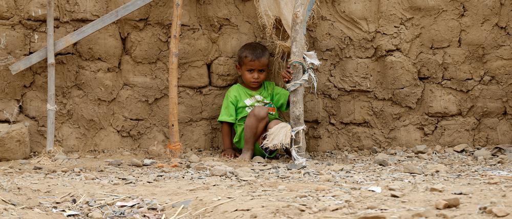 A boy sits near a hut in an improvised camp for internally displaced people near Abs of the northwestern province of Hajja, Yemen February 18, 2019. Picture taken February 18, 2019. REUTERS/Khaled Abdullah