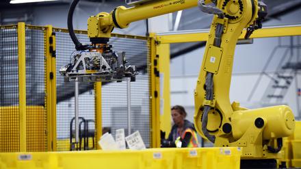 A robot prepares to pick up a tote containing product during the first public tour of the newest Amazon Robotics fulfillment center on April 12, 2019 in the Lake Nona community of Orlando, Florida. The over 855,000 square foot facility opened on August 26, 2018 and employs more than 1500 full-time associates who pick, pack, and ship customer orders with the assistance of hundreds of robots which can lift as much as 750 pounds and drive 5 feet per second. (Photo by Paul Hennessy/NurPhoto via Getty Images)