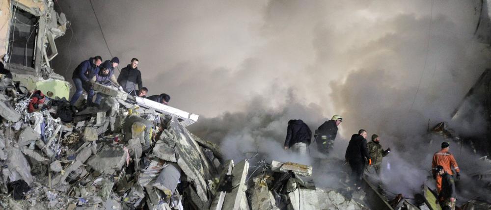 Rettungskräfte suchen nach Verschütteten in einem durch einen russischen Raketenangriff zerstörten Haus.