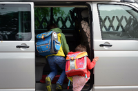 Kinder steigen in Großraum-Van, Symbolbild Elterntaxi. Foto: Ralf Hirschberger/dpa