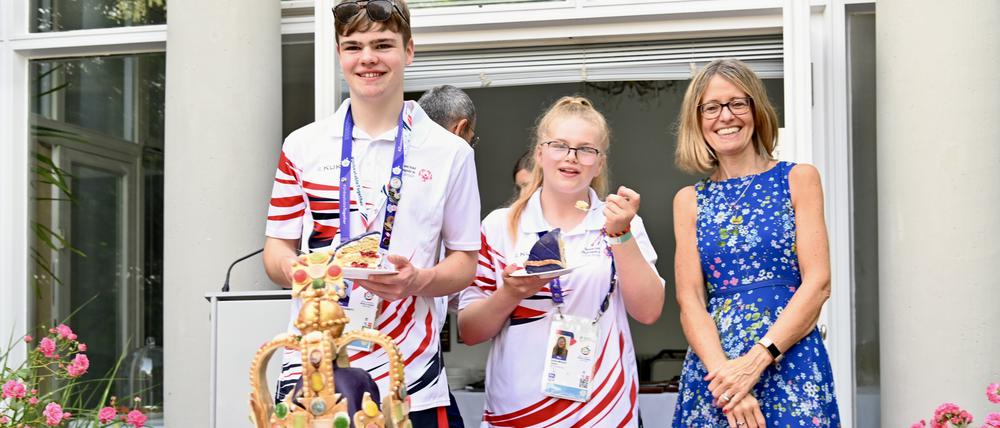Königlicher Kuchen. Großbritanniens Botschafterin Jill Gallard holt sich beim Anschneiden Unterstützung von britischen Teilnehmern an den Special Olympics. 