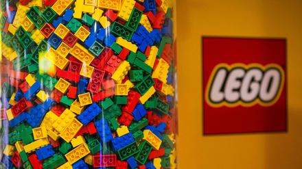 (FILES) LEGO bricks are displayed next to a LEGO logo at a shop in the hotel LEGOLAND on November 29, 2022, in Billund, Denmark. Danish toy giant Lego said on August 30, 2023 its net profit fell in the first half of the year but its market share grew as sales rose slightly. (Photo by Jonathan NACKSTRAND / AFP)