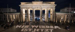 „Nie wieder ist jetzt“ steht während einer Lichteraktion von Fridays for Future Berlin gegen Rechtsextremismus vor dem Brandenburger Tor. Am 27. Januar ist der Tag des Gedenkens an die Opfer des Nationalsozialismus.