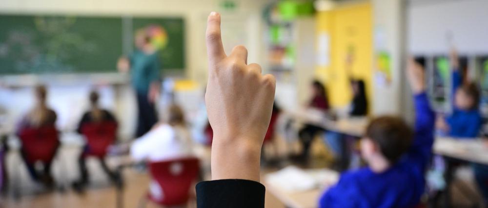 Schüler melden sich in einer vierten Klasse in einer Grundschule in Stuttgart.