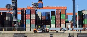 Container werden im Hafen von Rotterdam von Kränen transportiert und verladen. 
