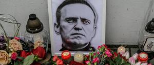 Flowers, candles, and a portrait of Alexei Navalny, who died in prison, are placed near the walls of the Russian Embassy in Warsaw. 
