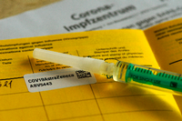 -Eine Person hält einen gelben Impfpass mit den Aufklebern vom Biontech-Pfizer-Impfstoff. Andreas Arnold/dpa