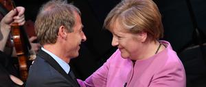 Der ehemalige Bundestrainer Jürgen Klinsmann und die frühere Bundeskanzlerin Angela Merkel (CDU) umarmen sich. 