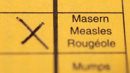 Ein Impfpass mit einem Kreuz bei der Masern-Impfung liegt auf einem Tisch. (Symbolbild)