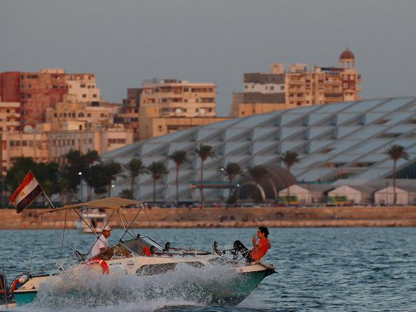 Menschen auf einem Boot vor der Bibliothek „Bibliotheca Alexandrina“ in Ägypten am 29. September 2022.