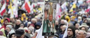 Menschen nehmen an einem Marsch zur Verteidigung des ehemaligen Papstes Johannes Paul II. teil.