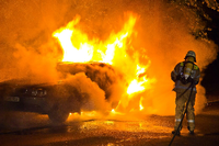Feuerwehrleute löschen ein brennendes Auto (Archivbild). Foto: Steffen Tzscheuschner/dpa