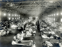 Patienten, die an der Spanischen Grippe erkrankt sind, liegen in Betten eines Notfallkrankenhauses im Camp Funston der Militärbasis Fort Riley in Kansas (USA). Foto: picture alliance / National Museum of Health and Medicine 