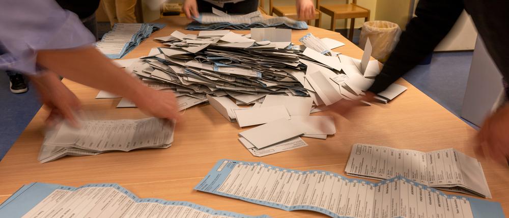 Wahlhelfer sortieren nach der wiederholten Wahl zum Abgeordnetenhaus am 12. Februar die Stimmzettel in einem Wahllokal in der Grundschule am Teutoburger Platz in Prenzlauer Berg.