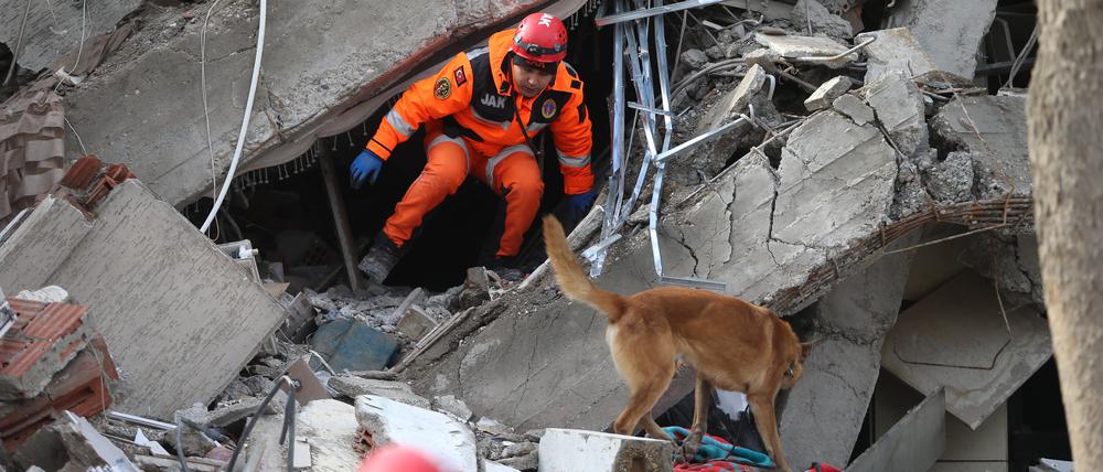 Ein Retter sucht nach dem Erdbeben in den Trümmern eines Gebäudes im türkischen Kahramanmaras nach Überlebenden.