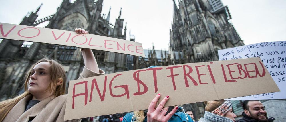 Eine Frau protestiert am 10.01.2016 in Köln vor dem Hauptbahnhof und dem Dom gegen sexuelle Gewalt mit einem Plakat "Angstfrei leben". Das gilt auch andernorts.