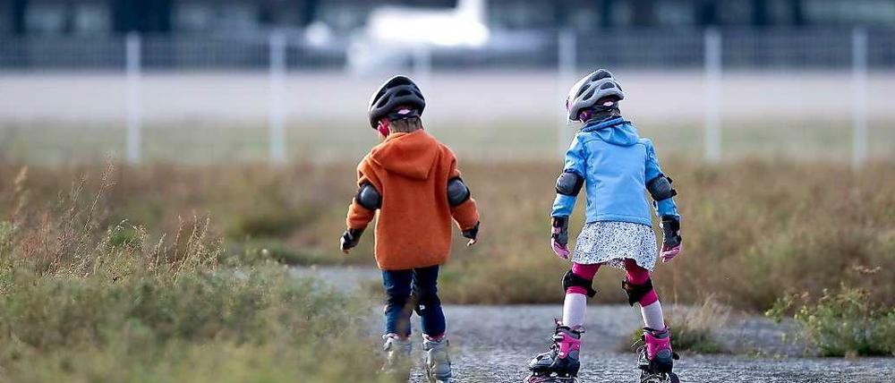 Kinder, die auf dem Tempelhofer Feld inlineskaten.