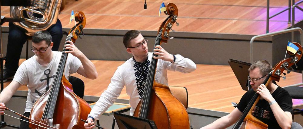 Musik ist Identität. Die Kontrabassisten haben beim Konzert in der Berliner Philharmonie Fähnchen an ihre Instrumente gesteckt. 