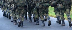 Bundeswehr-Soldaten in der Grundausbildung marschieren.