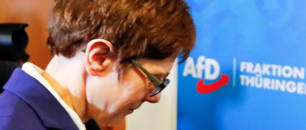 Annegret Kramp-Karrenbauer, chairwoman of Germany&amp;apos;s conservative Christian Democratic Union party CDU walks past a sign of Germany&amp;apos;s far-right Alternative for Germany (AFD) party following a meeting at the federal parliament of the state of Thuringia in Erfurt, Germany February 7, 2020. REUTERS/Wolfgang Rattay